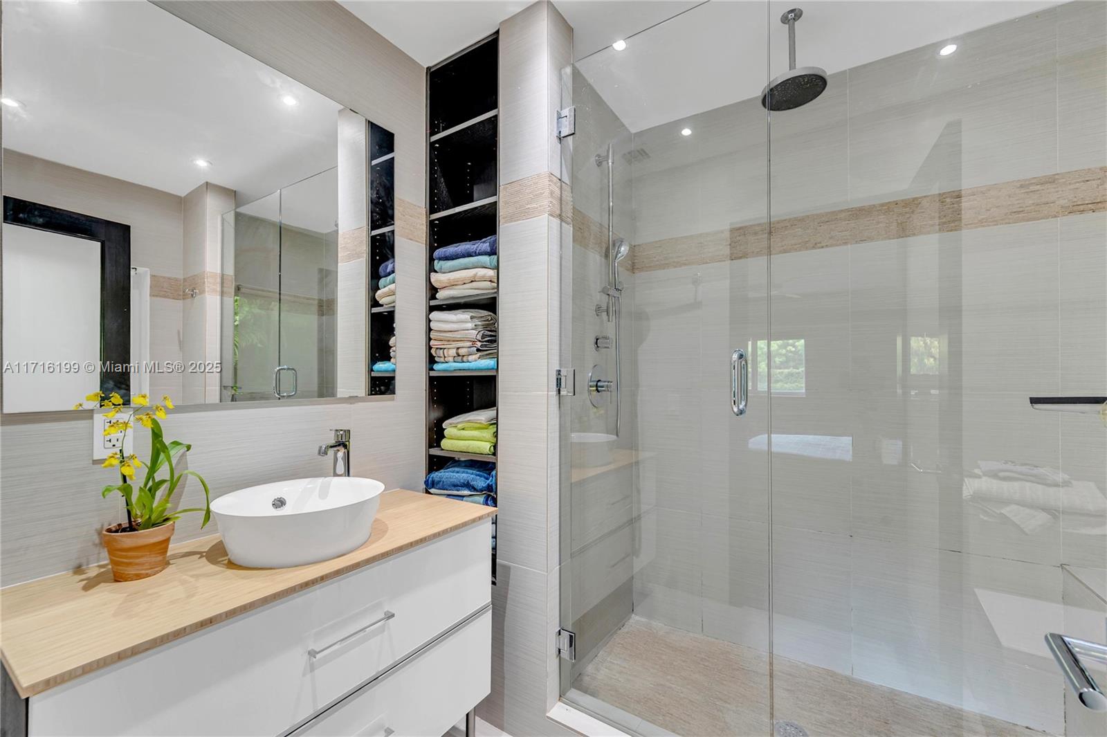 203 Ridgewood Road Coral Gables, FL 33133 - Photo 27 of 46 a bathroom with a shower sink and mirror