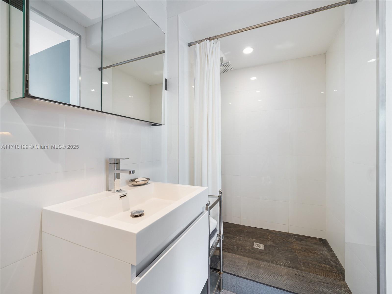 203 Ridgewood Road Coral Gables, FL 33133 - Photo 30 of 46 a bathroom with a sink mirror and vanity