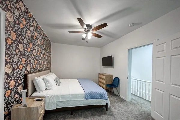a large bed sitting in a bedroom next to a window