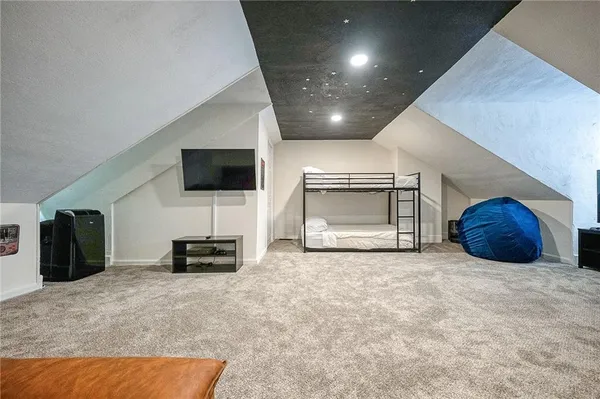 a bedroom with a bed and a couch