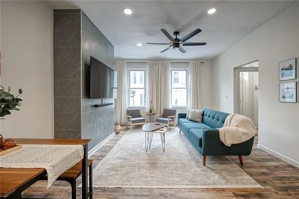 a living room with furniture and a flat screen tv