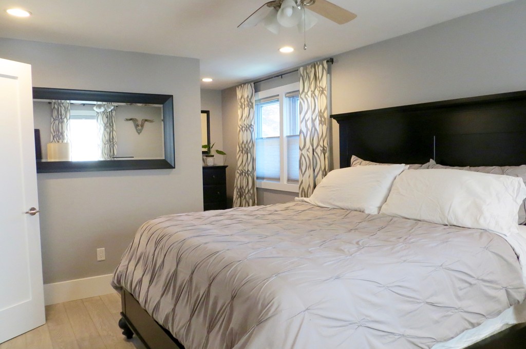 12 Back River Road Amesbury, MA 01913 - Photo 12 of 30 a bedroom with a bed and a flat screen tv