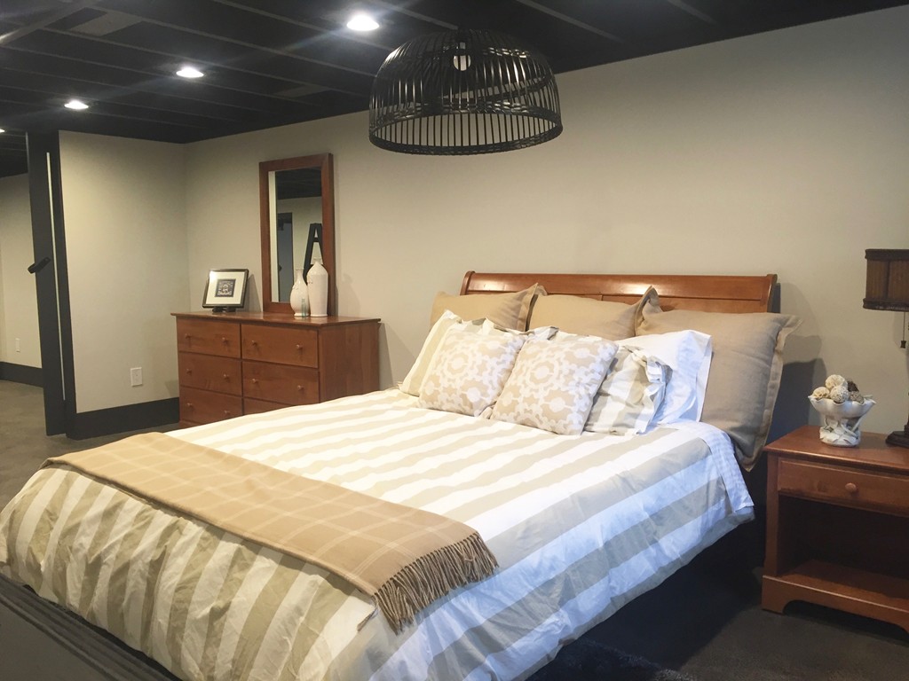 12 Back River Road Amesbury, MA 01913 - Photo 21 of 30 a bedroom with a bed and a chandelier