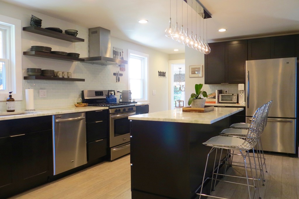 12 Back River Road Amesbury, MA 01913 - Photo 3 of 30 a kitchen with stainless steel appliances a refrigerator a sink a stove a microwave and wooden floor