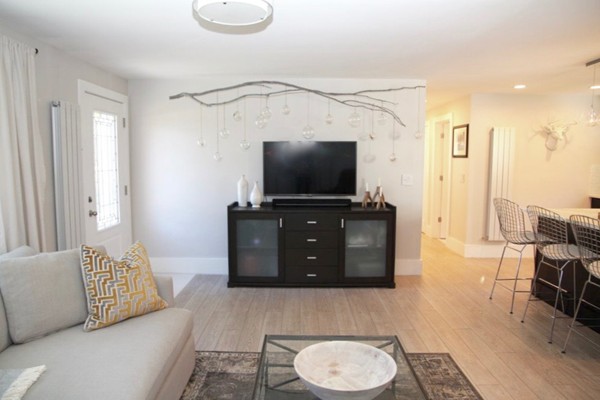 12 Back River Road Amesbury, MA 01913 - Photo 6 of 30 a living room with furniture and a flat screen tv