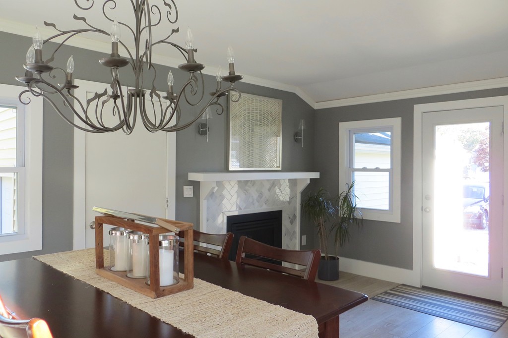 12 Back River Road Amesbury, MA 01913 - Photo 10 of 30 a view of a livingroom with furniture window wooden floor and a fireplace