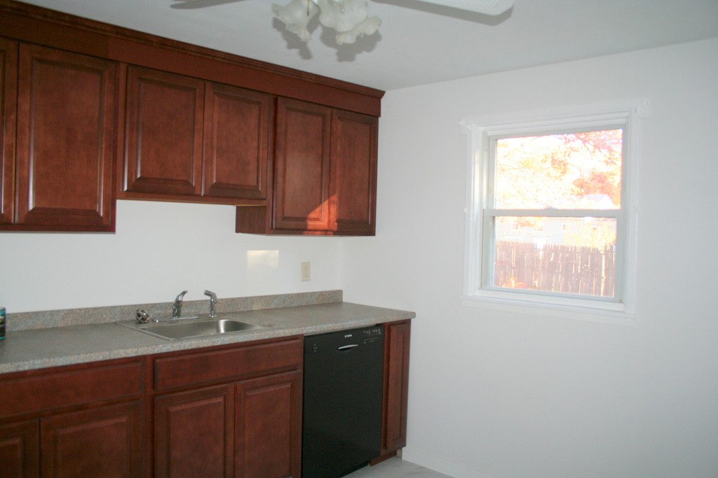 99 Eddy Street Springfield, MA 01104 - Photo 5 of 13 a kitchen with a sink and cabinets