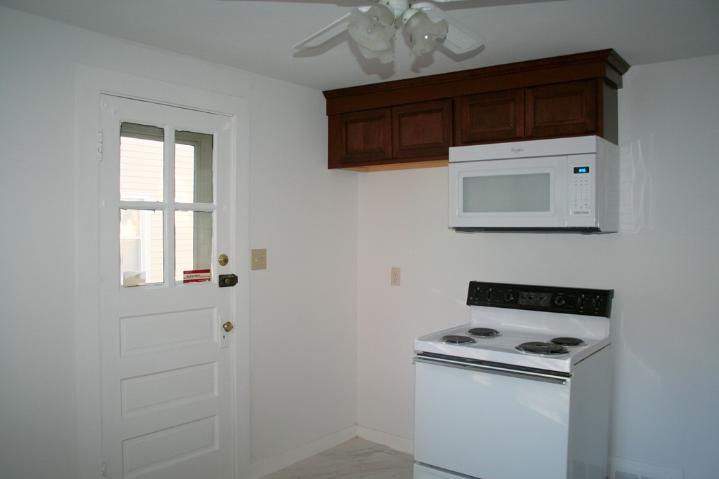 99 Eddy Street Springfield, MA 01104 - Photo 6 of 13 a kitchen with a stove and a microwave