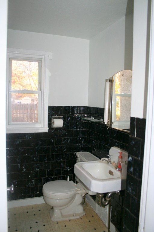 99 Eddy Street Springfield, MA 01104 - Photo 7 of 13 a bathroom with a sink a toilet a mirror and vanity
