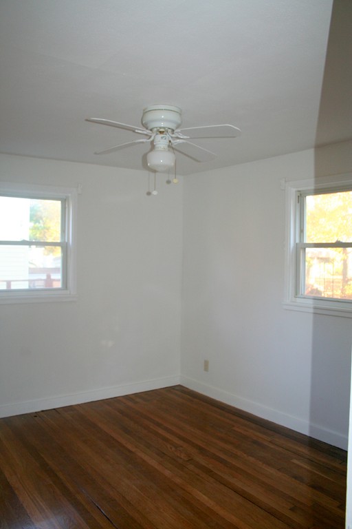 99 Eddy Street Springfield, MA 01104 - Photo 8 of 13 a view of an empty room with wooden floor and a window