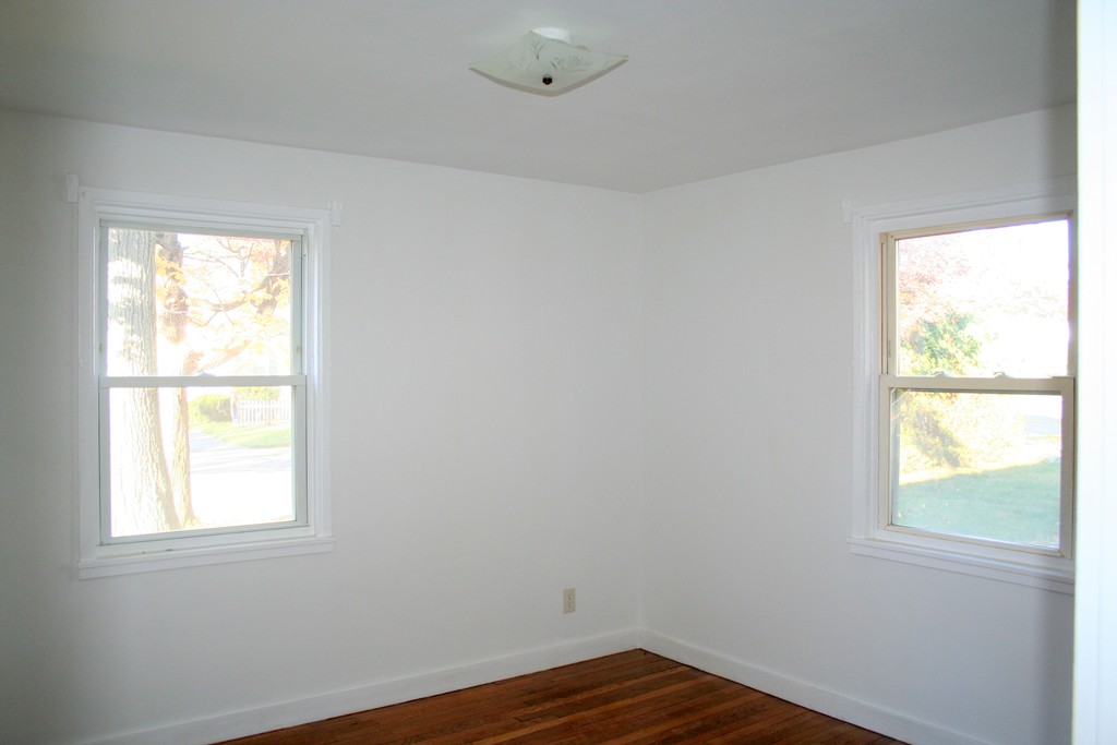 99 Eddy Street Springfield, MA 01104 - Photo 10 of 13 a view of an empty room with wooden floor and a window