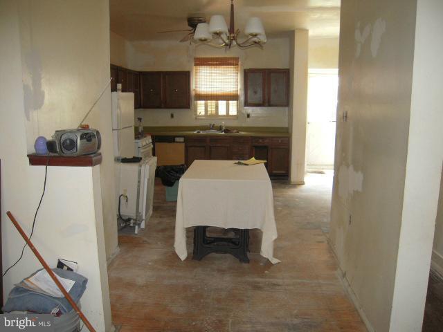 a living room with furniture a window and kitchen view