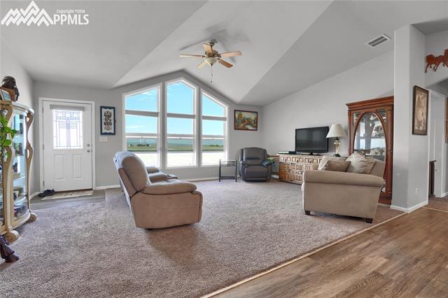 9990 North Log Road Calhan, CO 80808 - Photo 10 of 29 Spacious living room with vaulted ceiling