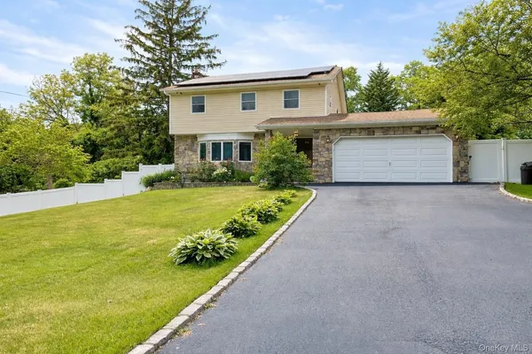 a view of a house with garden and yard