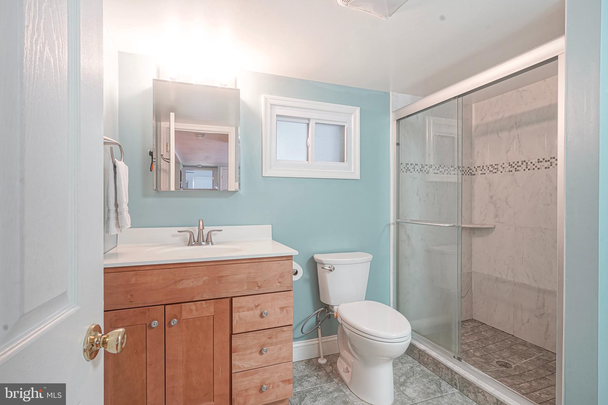 407 Hamilton Road Glassboro, NJ 08028 - Photo 15 of 31 a bathroom with a toilet sink and mirror