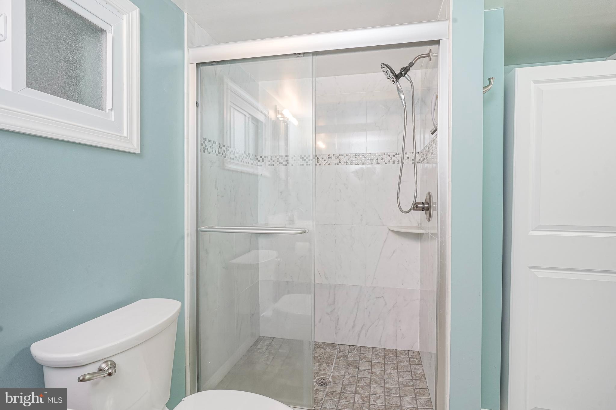407 Hamilton Road Glassboro, NJ 08028 - Photo 16 of 31 a white toilet sitting next to a bathroom sink