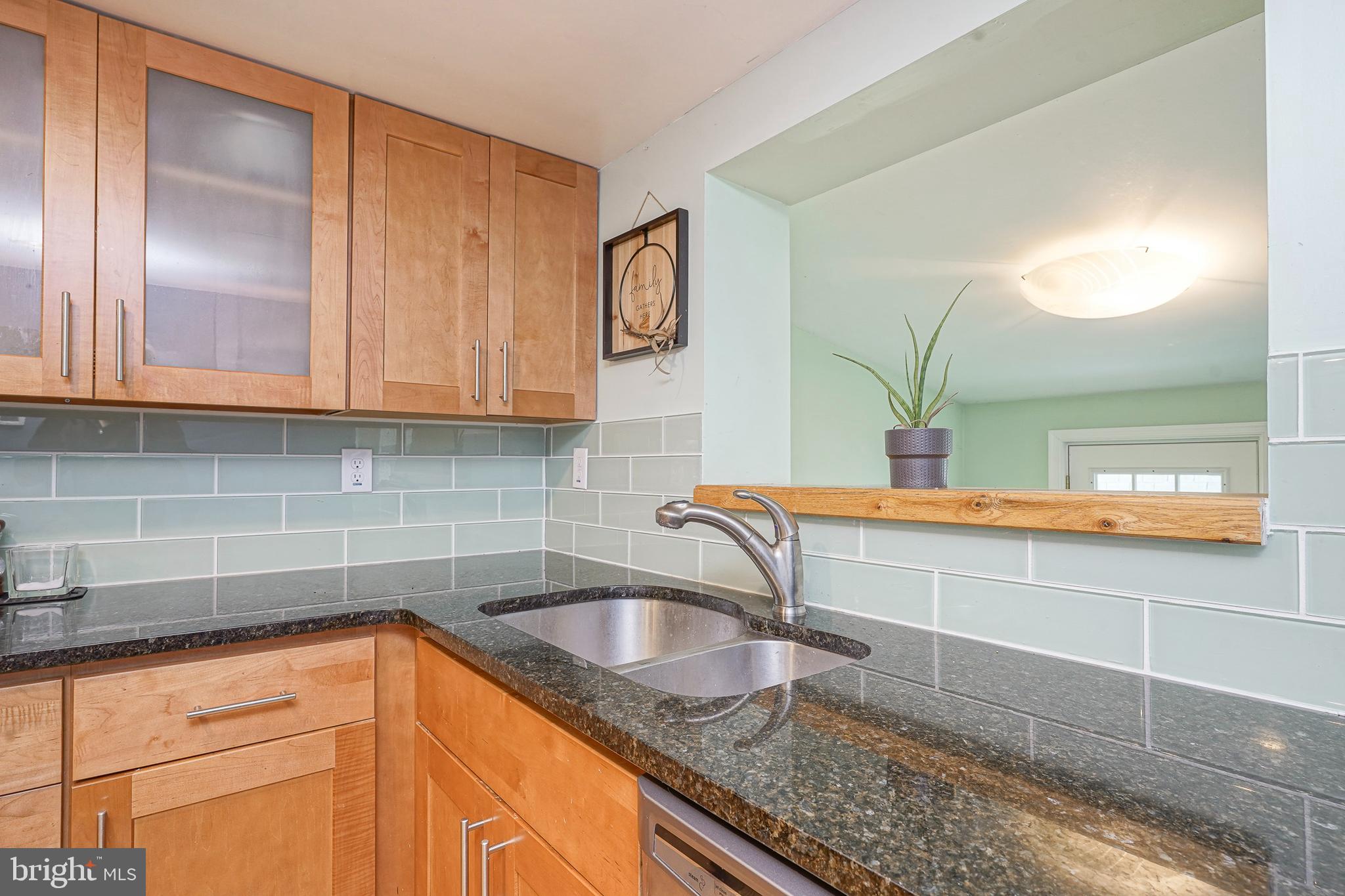 407 Hamilton Road Glassboro, NJ 08028 - Photo 5 of 31 a kitchen with granite countertop a sink and a stove