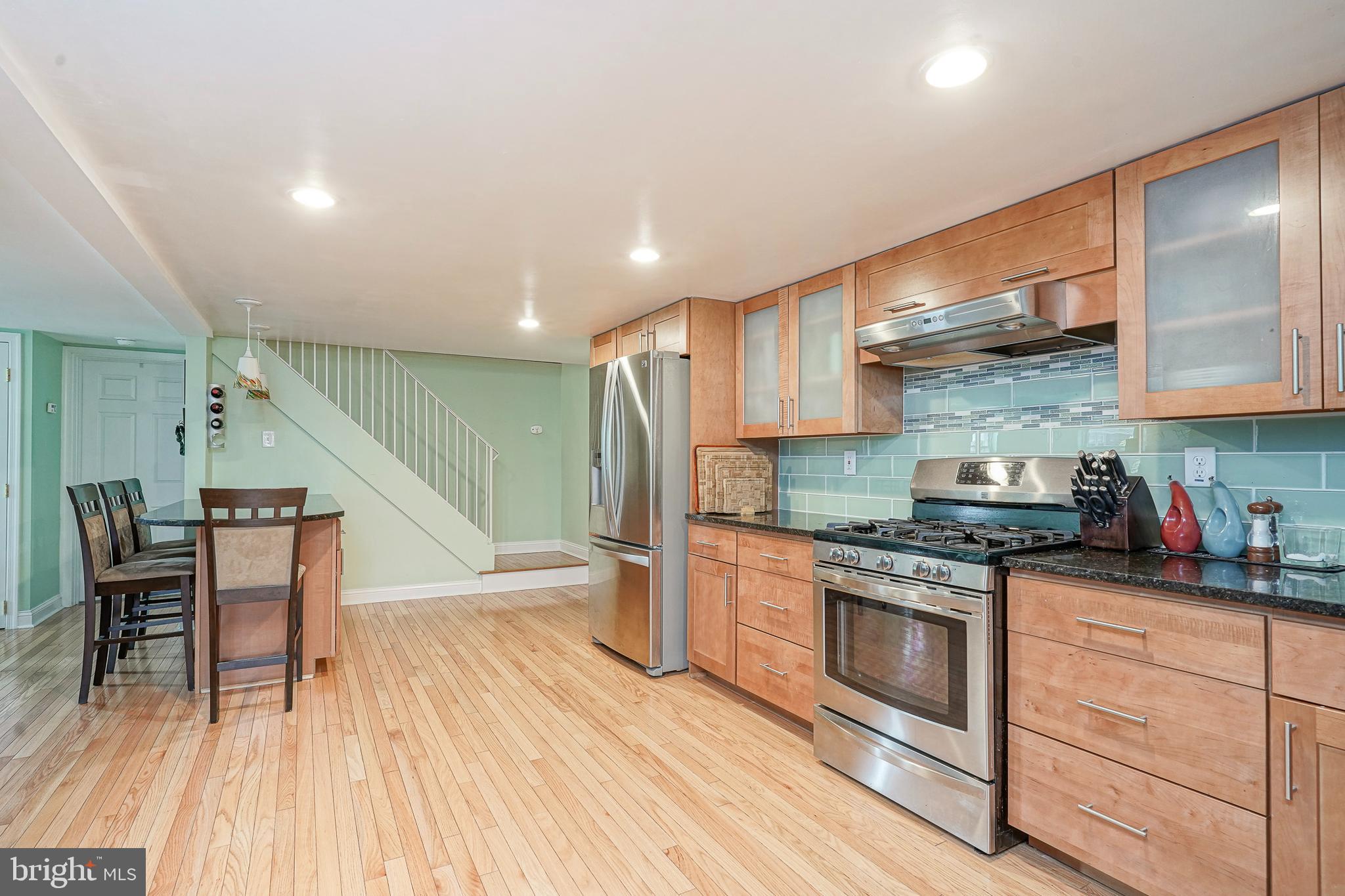 407 Hamilton Road Glassboro, NJ 08028 - Photo 7 of 31 a kitchen with stainless steel appliances granite countertop a stove and a wooden floors