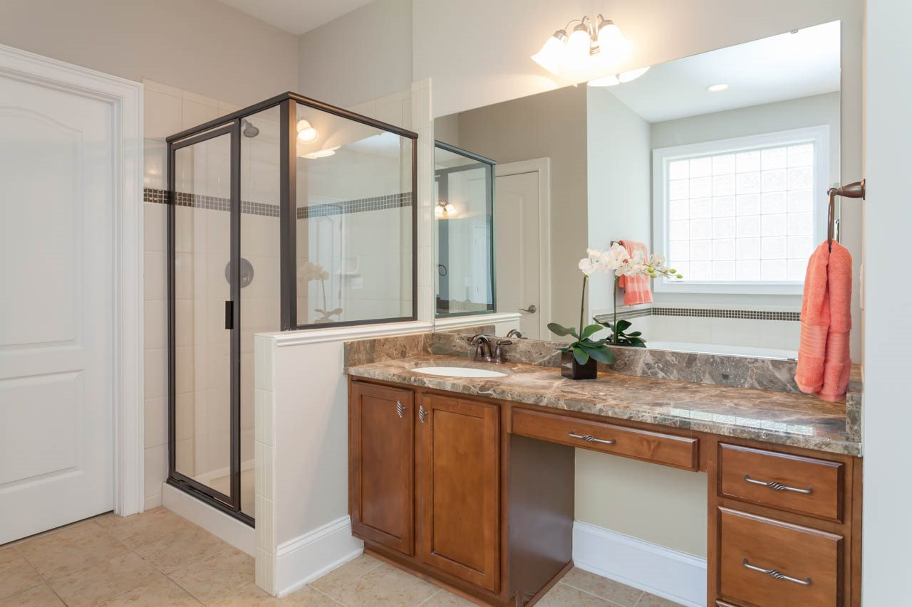 8915 Scotch Castle Drive Raleigh, NC 27612 - Photo 12 of 25 The master bath features two separate vanities and oil rubbed bronze hardware. Master Bath