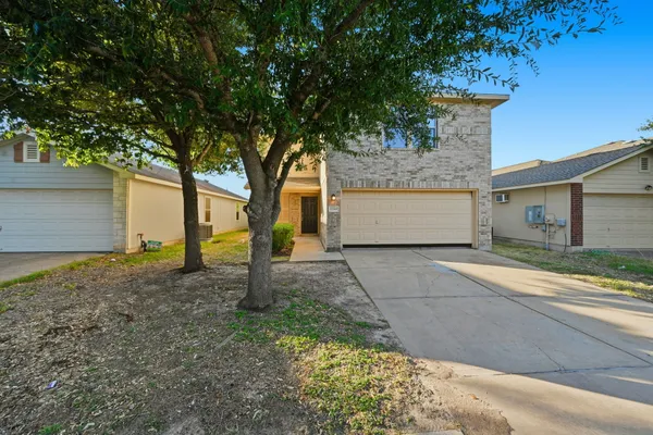 a front view of a house with a yard and garage