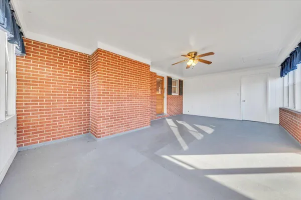 a view of an empty room with a ceiling fan
