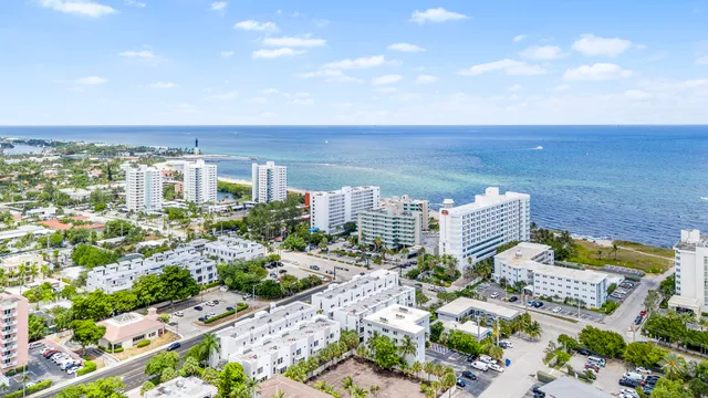 a view of a patio with table and chairs and potted plants