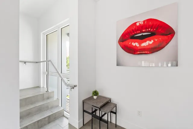 a bathroom with a granite countertop toilet a sink a shower and a window
