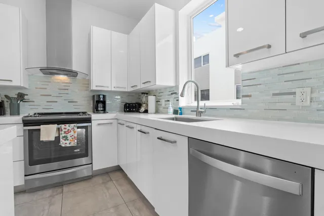 a bathroom with a granite countertop sink mirror and toilet