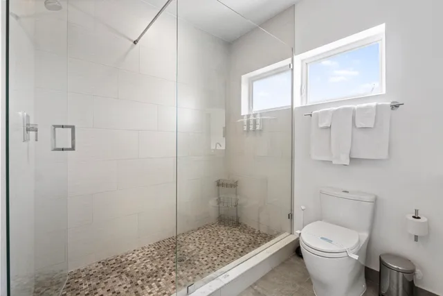 a white toilet sitting next to a bathroom sink