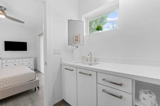 a kitchen view with potted plants and a table