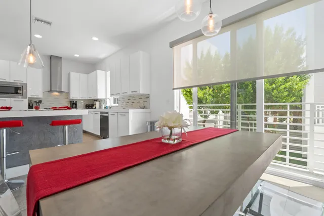 a living room with furniture and kitchen view