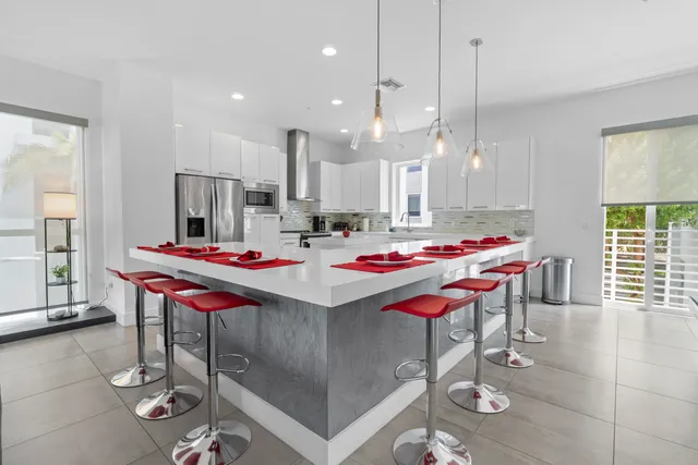 a kitchen with appliances a sink and cabinets