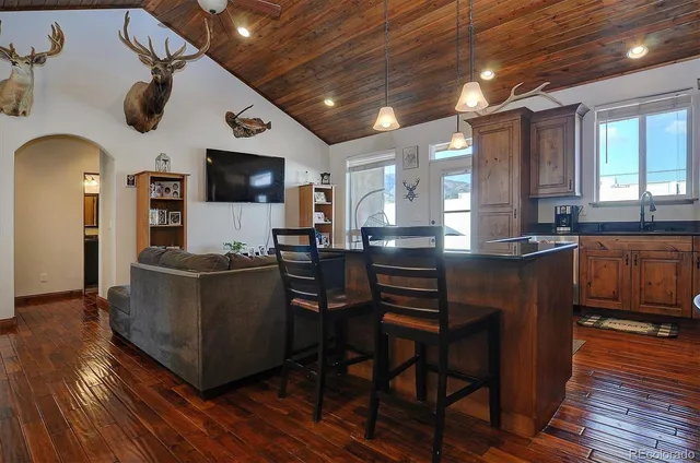 a kitchen with stainless steel appliances granite countertop a sink a stove and a refrigerator