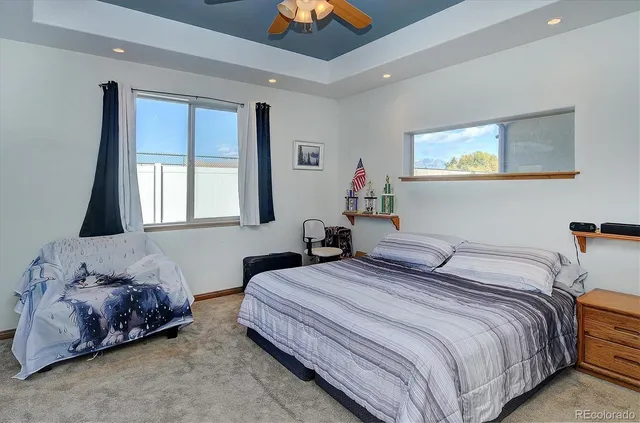 a bedroom with a bed and a large window