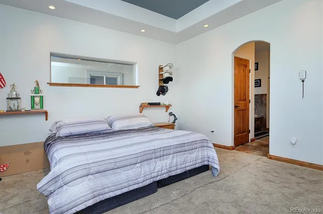 a bedroom with a bed and lamp