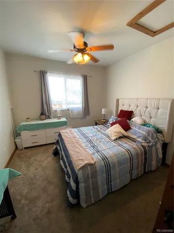 a bedroom with a bed dresser and a window