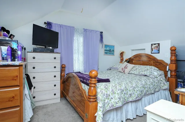 a bedroom with a bed and flat screen tv