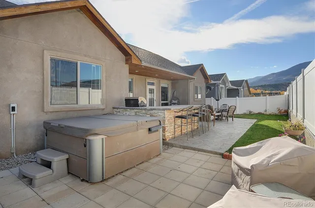 a view of a house with backyard and sitting area
