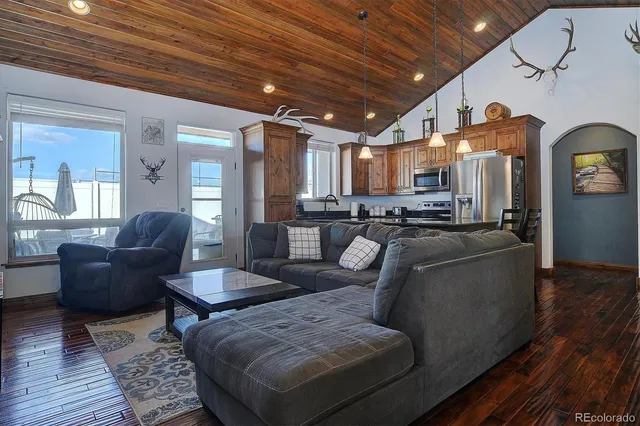 a living room with furniture and a chandelier