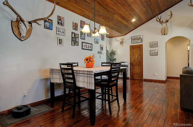 a dining room with furniture wooden floor a chandelier
