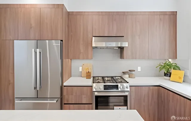 a kitchen with a sink a window and chairs