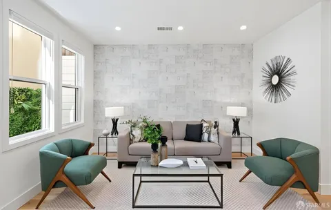 a living room with furniture and a potted plant