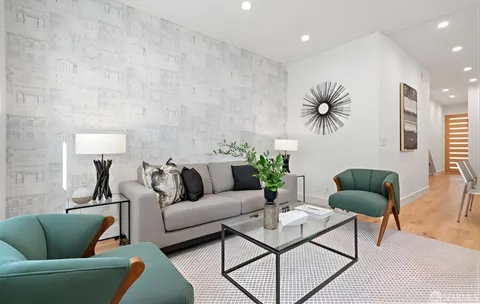 a dining room with furniture and wooden floor
