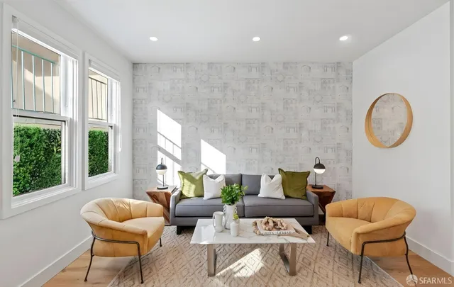 a living room with furniture and large windows