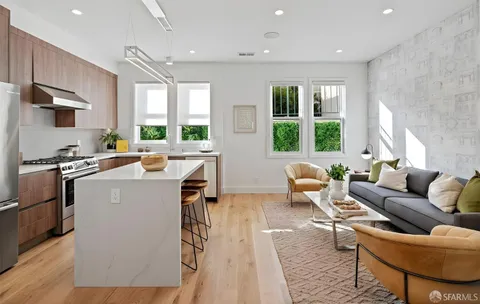 a kitchen with a refrigerator a stove a sink dishwasher and white cabinets with wooden floor