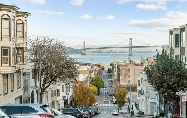 a store with couple of cars parked in front of it