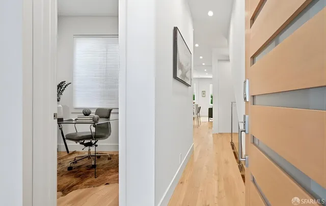 a kitchen with stainless steel appliances granite countertop a refrigerator a stove a sink dishwasher a dining table and chairs with wooden floor