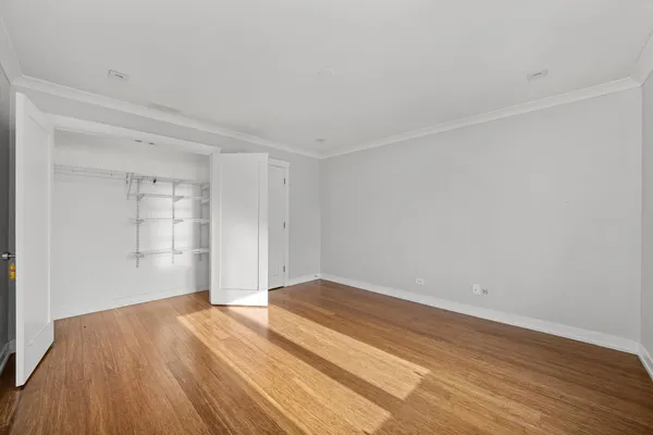 a view of empty room with wooden floor