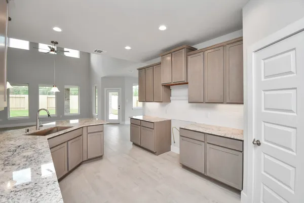 a kitchen with a sink cabinets and window