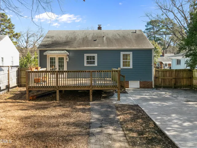 a view of a house with a yard and deck